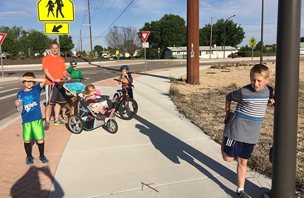 A Dad and five kids on a walk. 