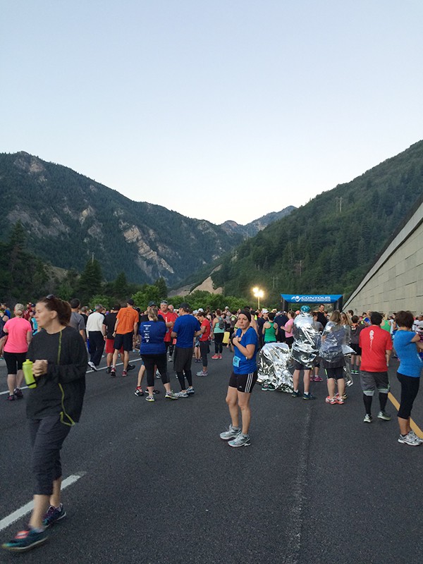 A group of people in a mountain setting waiting to run a race. 