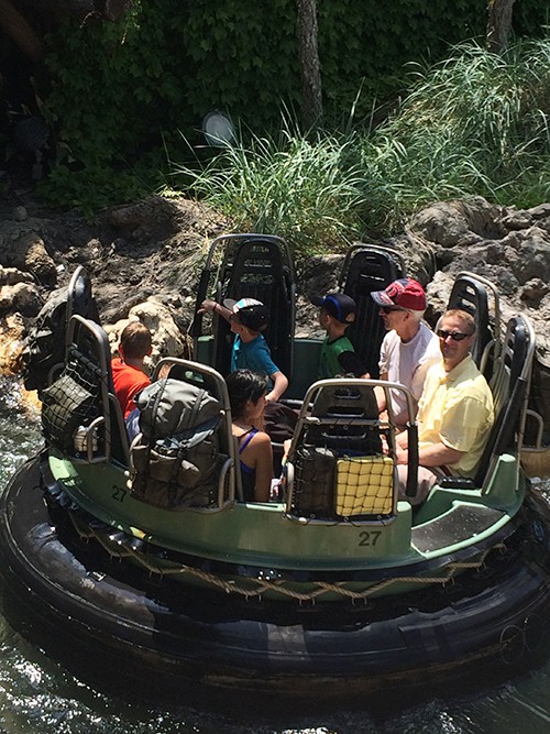 A family on a water ride in Disneyland.