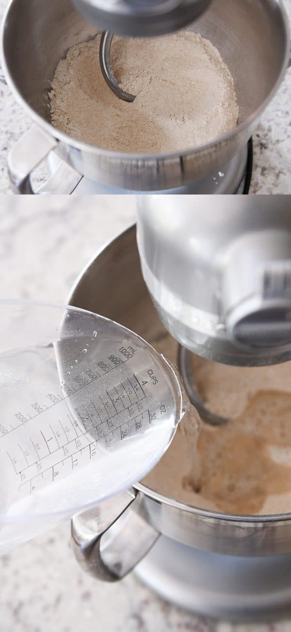 Water and flour getting mixed with a dough hook in a metal KitchenAid bowl.