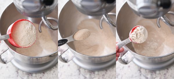 flour, vital wheat gluten, and yeast getting poured into a bowl of whole wheat bread dough