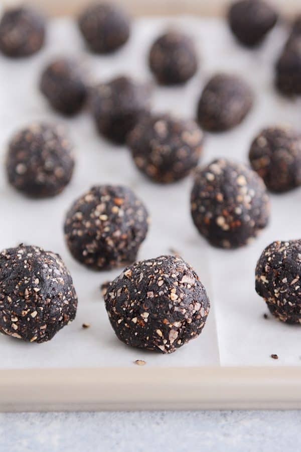 Healthy Dark Chocolate Almond Joy Bites on a piece of parchment. 