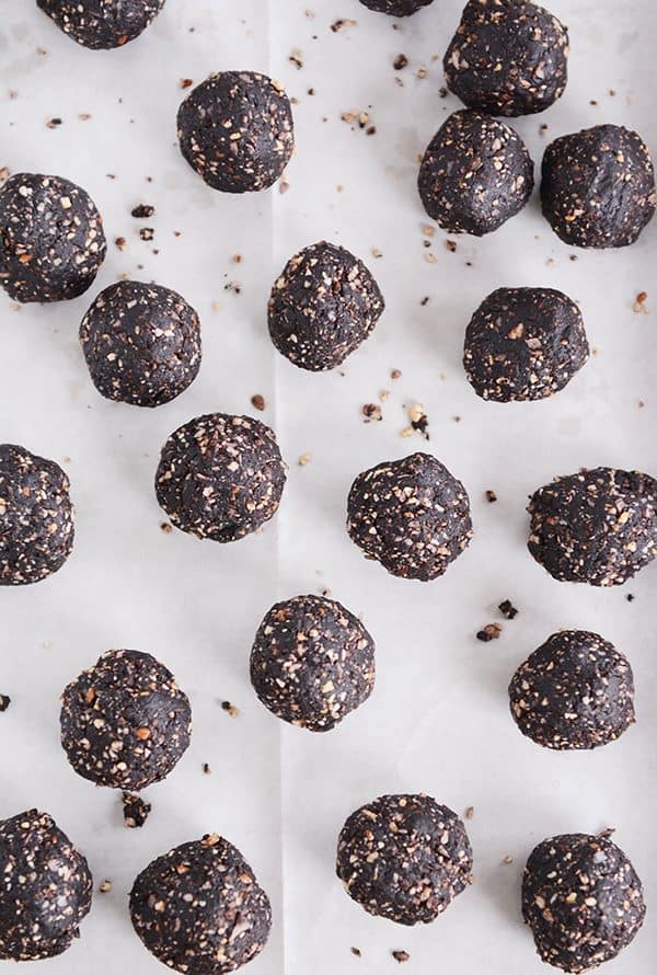 Dark chocolate almond joy bites on a sheet of parchment.