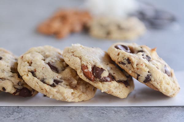 Almond and chocolate chunk cookies stacked side-by-side.