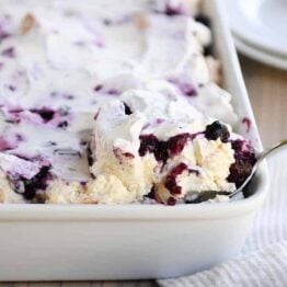 Scooping out a serving of heavenly blueberries and cream angel food cake dessert.