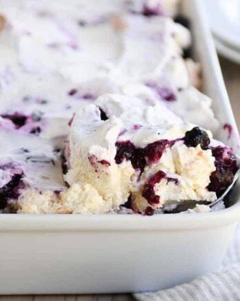 Scooping out a serving of heavenly blueberries and cream angel food cake dessert.