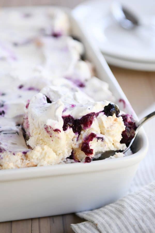Scooping out a serving of heavenly blueberries and cream angel food cake dessert.