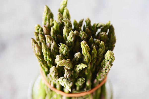 A top view of a rubber-banded bunch of asparagus.