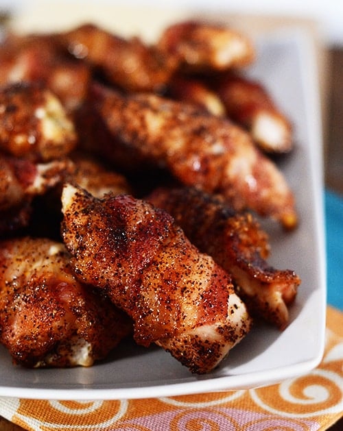 A white platter of bacon-wrapped chicken bites. 
