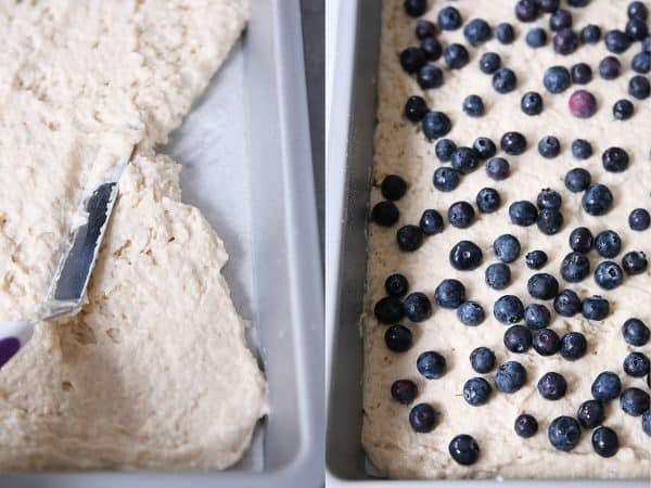 Spreading pancake batter in the pan and topping with fresh blueberries.