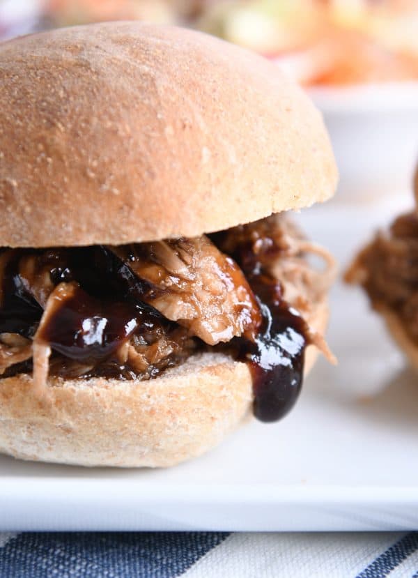 Closeup of honey balsamic bbq pork sandwich on white tray.