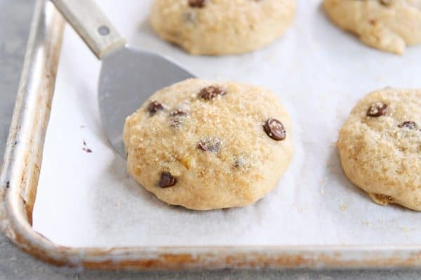 Soft banana bread cookie on baking pan with spatula.