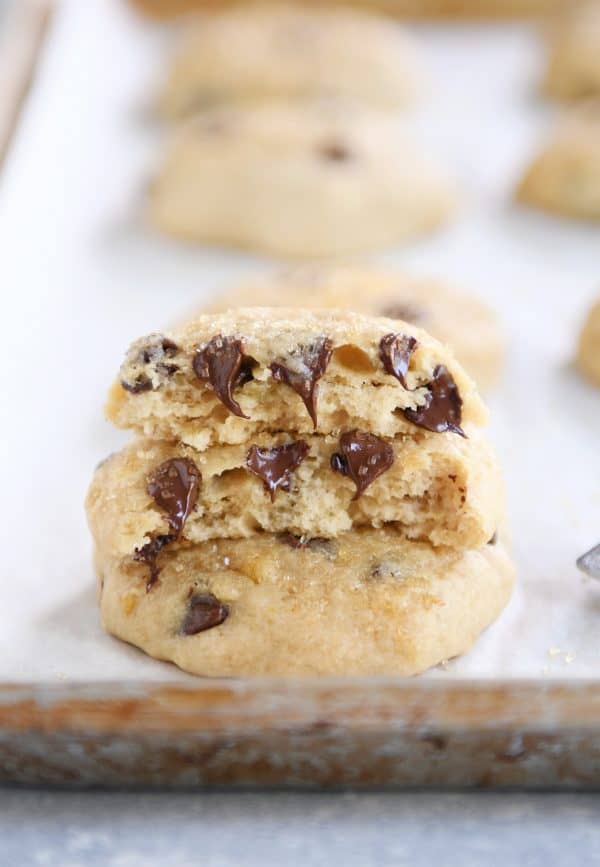 Soft banana bread cookie in half on baking sheet.