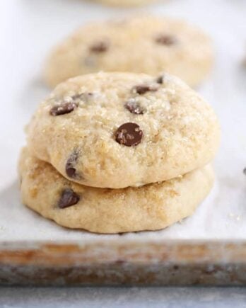 Stack of soft banana bread cookies on white napkin.