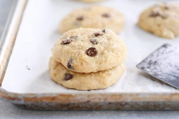 Stack of soft banana bread cookies on white napkin.