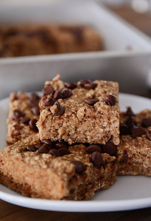 A white plate with four banana oat chocolate chip bars.