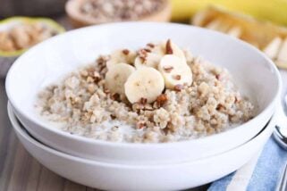 White bowl filled with Instant Pot banana bread steel cut oats with sliced bananas and milk.