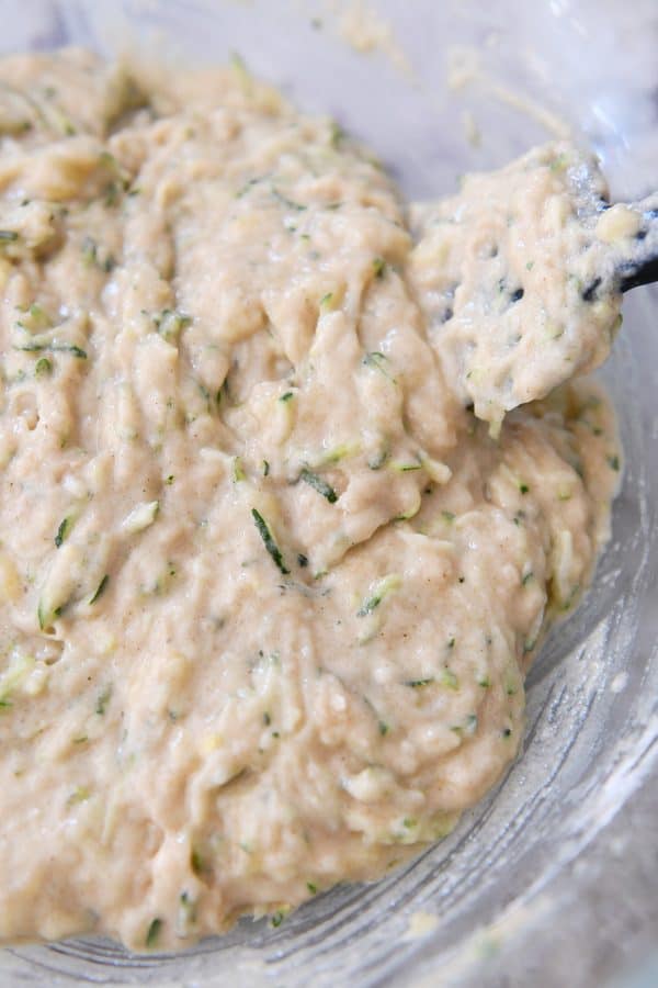 Glass bowl with mixed zucchini banana bread batter.