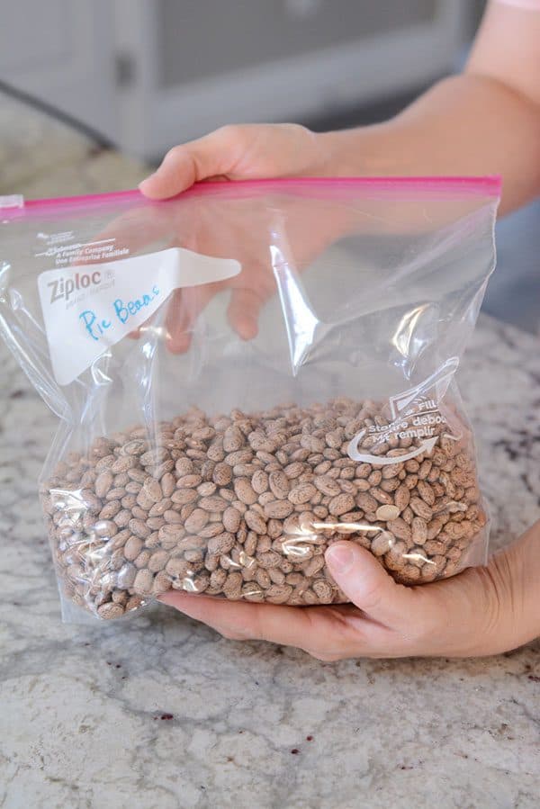 A gallon size Ziploc bag half full of dry pinto beans. 