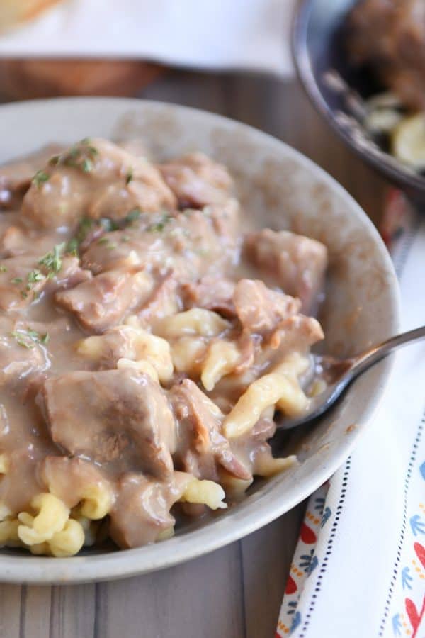 Forkful of slow cooker beef stroganoff over spaetzle.