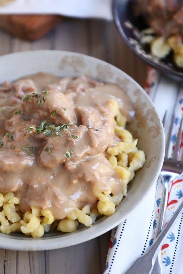 Bowl of slow cooker beef stroganoff over spaetzle.