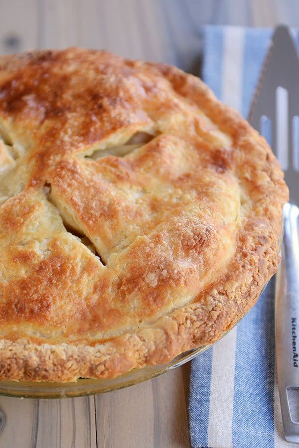 Top view of a cooked apple pie with slits cut in the top.