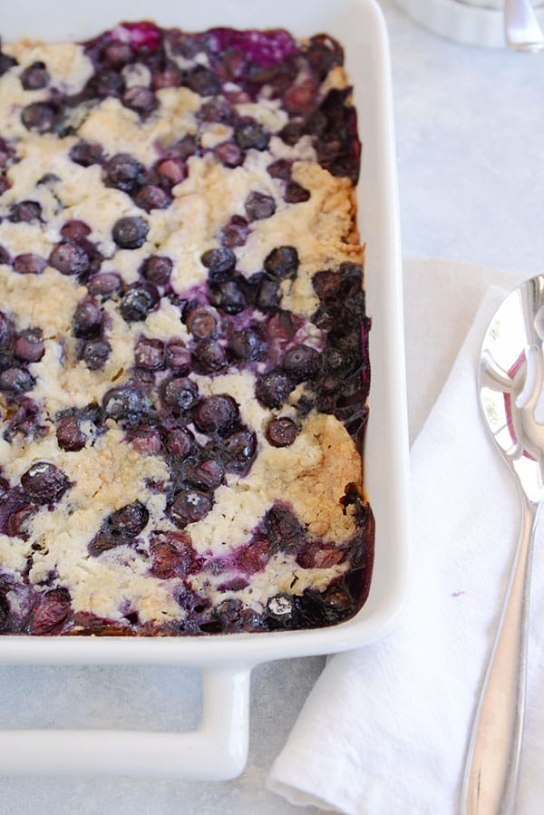This tried-and-true, easy recipe for blueberry dump cake is made with a simple cake mix, fresh or frozen blueberries, butter, and milk. No mixing!