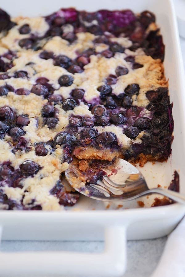 This tried-and-true, easy recipe for blueberry dump cake is made with a simple cake mix, fresh or frozen blueberries, butter, and milk. Minimal mixing!