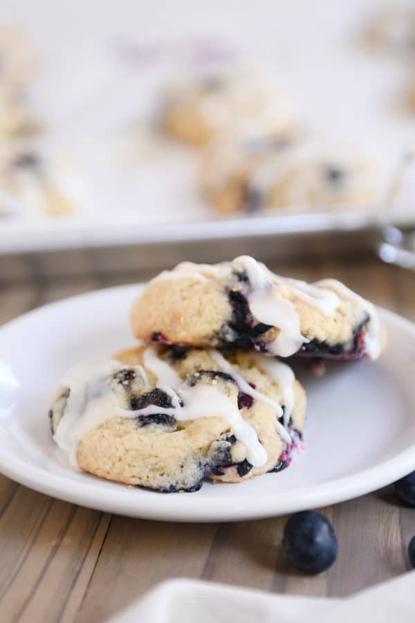 Two blueberry muffin cookies on white plate. 