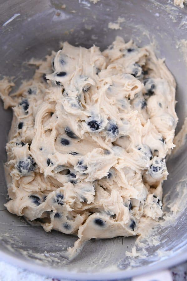 Blueberry muffin cookie batter in stainless bowl.
