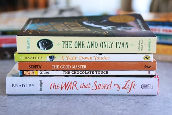 A stack of books on a kitchen counter.