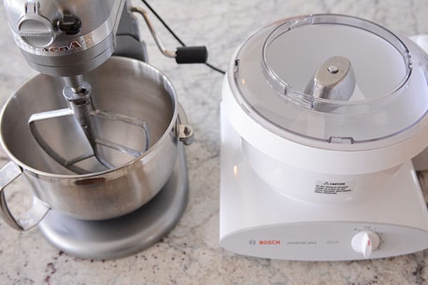 A Kitchen Aid and Bosch Mixer side-by-side on a countertop.