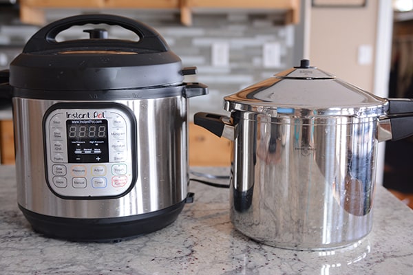 Two pressure cookers on a kitchen counter.