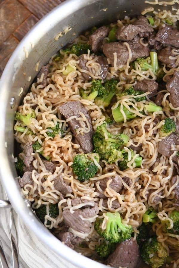 Top down view of beef and broccoli ramen noodles in pot.