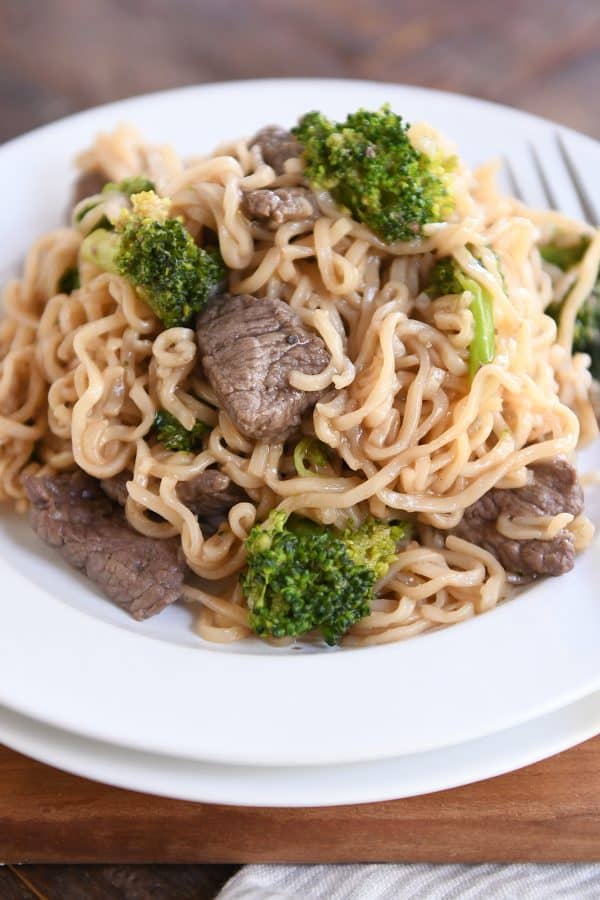 White plate piled high with easy one pot beef and broccoli ramen noodles.