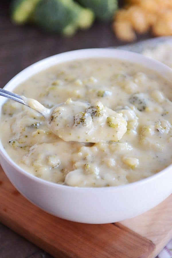 Spoonful of homemade broccoli cheese soup in white bowl.