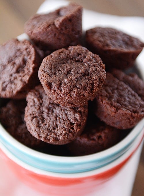 A bowl full of chocolate brownie bites.