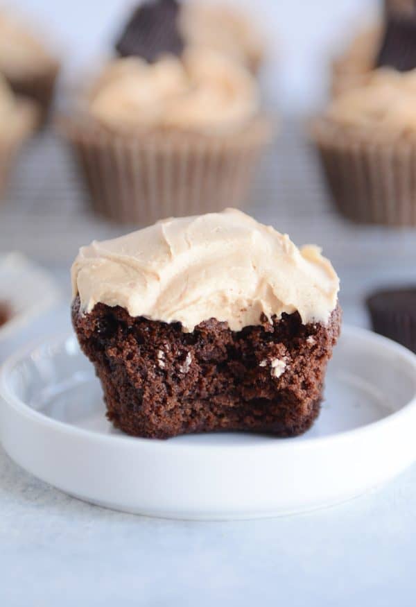 Fudgy brownie cupcake with the best peanut butter frosting with bite taken out.