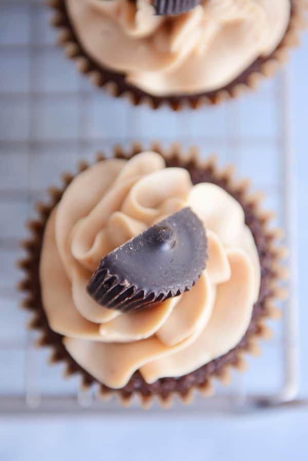 Top down view of a fudgy brownie cupcake with the best peanut butter frosting and half of a peanut butter cup.