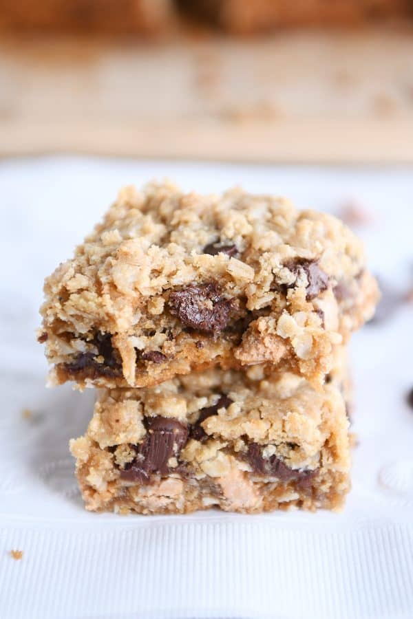 Two butterscotch PB monster cookie bars stacked on each other with bite taken out.