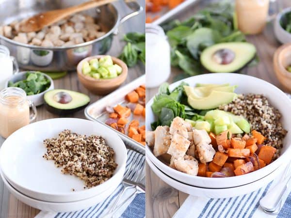 Assembling Buddha bowls in white bowls with quinoa, chicken, sweet potatoes, avocado.