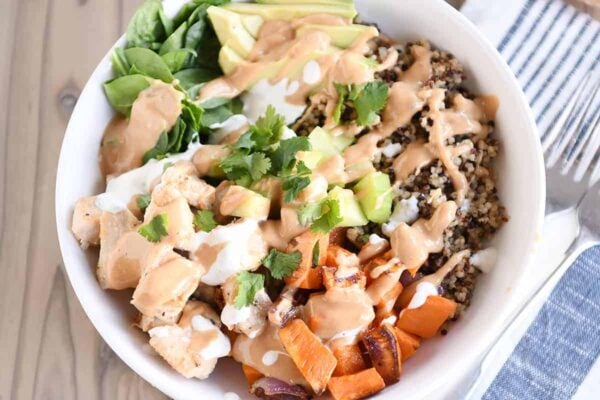 Landscape view Top down view of Buddha bowl recipe with peanut sauce.