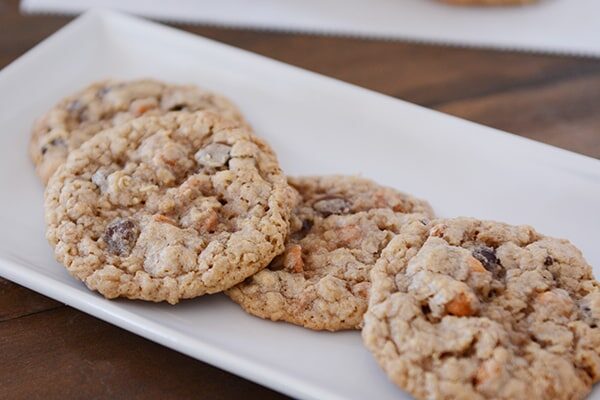 A white tray of oatmeal chocolate chip butterscotch cookies. 