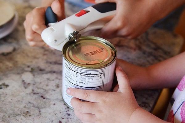 A can opener opening a can. 