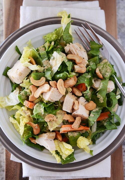 Top view of a plate full of chicken cashew salad. 