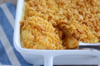 Scooping out a spoonful of cheesy funeral potatoes