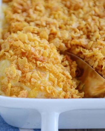 Scooping out a spoonful of cheesy funeral potatoes