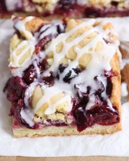 Cherry pie cookie bar on white napkin.