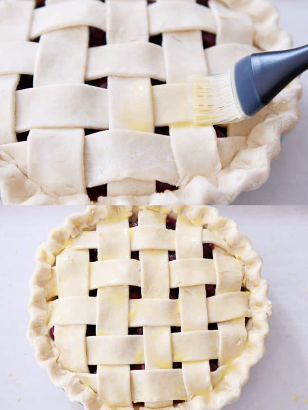 Brushing beaten egg on top crust of cherry pie.