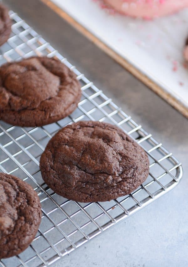 Chocolate brownie cookies on a cooling rack.